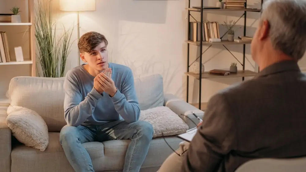 A male patient speaking with a psychiatrist
