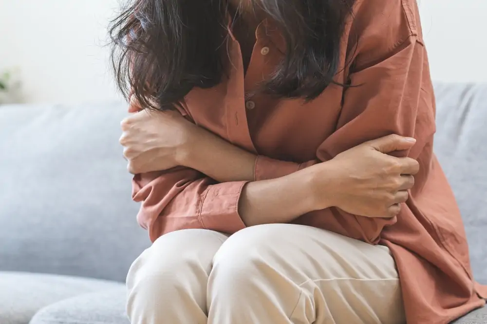 A nervous woman with folded arms